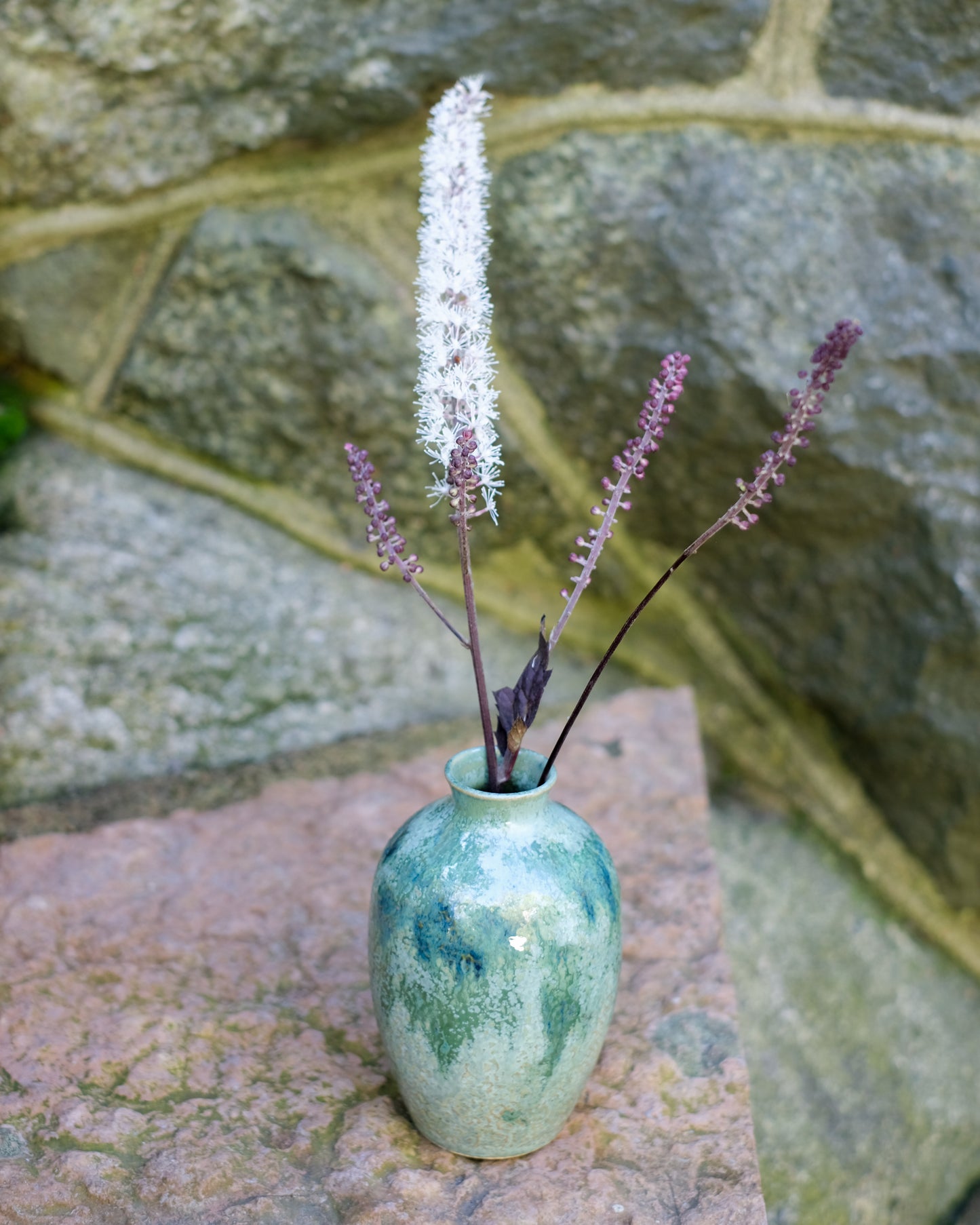 Knackad vas grönmelerad